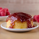 A sponge pudding drenched in raspberry sauce