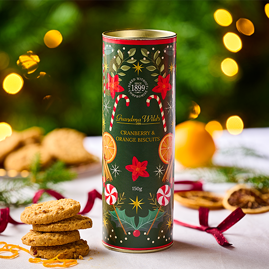 A tube of Orage & cranberry biscuits decorated with candy canes