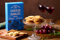 Cheese Sables on a platter with a glass of red wine at the side